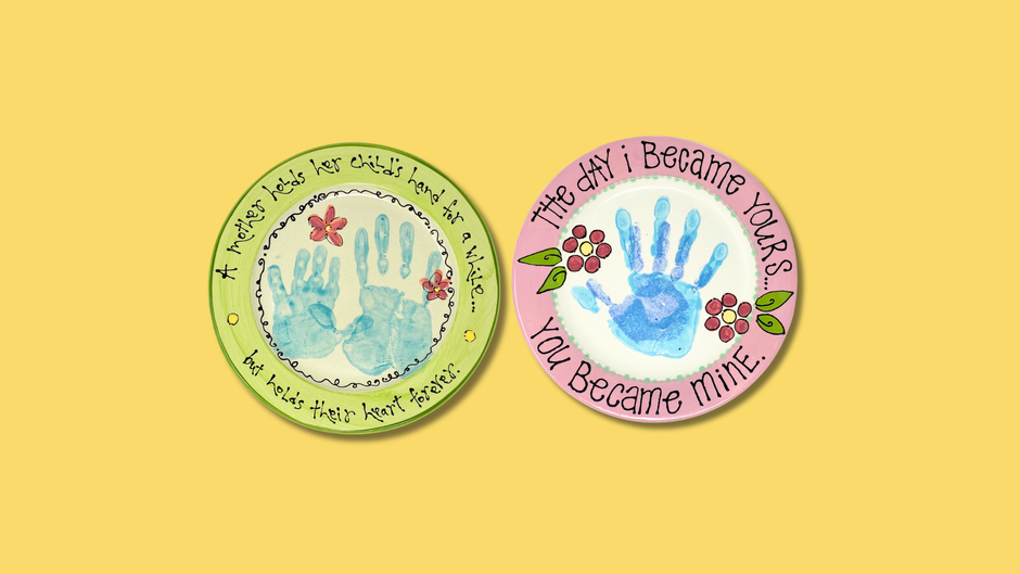 Two decorative plates with Mother's Day hand print designs on a yellow background
