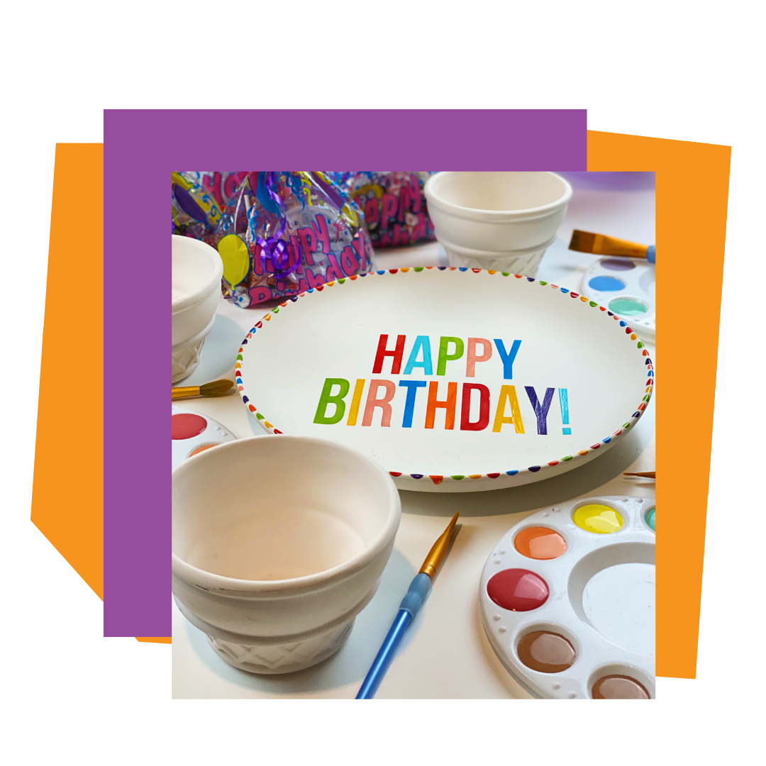 Painted ceramic plate with 'Happy Birthday!' text on a table with supplies for a birthday party to go.
