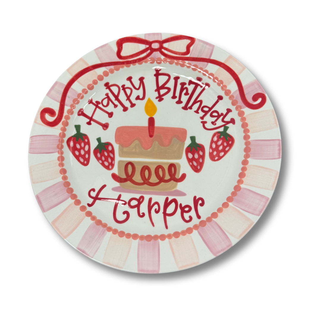 Round plate with 'Happy Birthday Harper' text and cake design on a white background